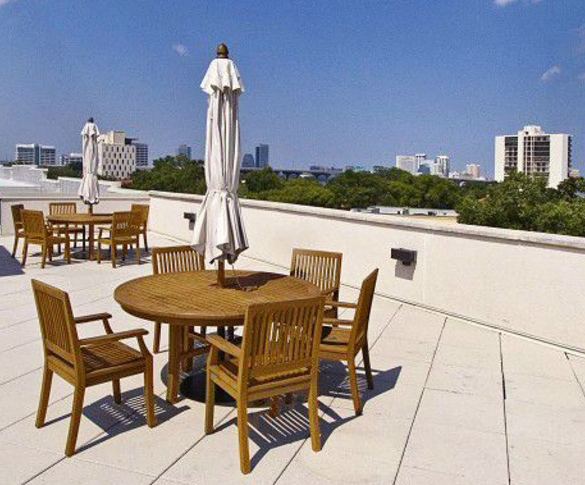 teak tables and chairs with umbrellas at 1661 Riverside in Jacksonville